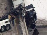 Semi Dangles Off Bridge After Crash