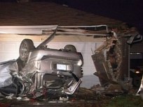 SUV Flips Into 2 Garages; Man Dies