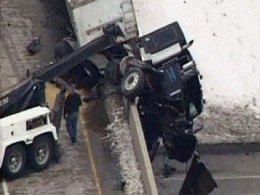Semi Dangles Off Bridge After Crash