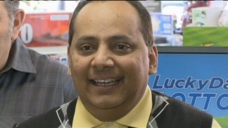 Raw: Poisoned Lottery Winner Receives Check