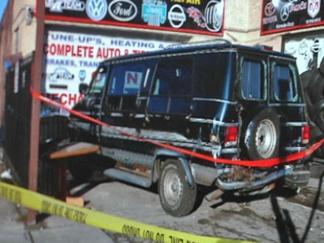 Surveillance Video Shows Van Crashing into Repair Lot
