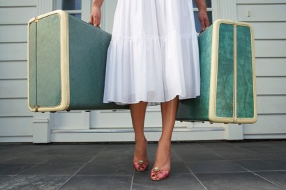 Woman carrying two suitcases