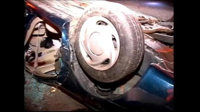 A car with a mother and baby inside flips off a highway overpass, landing upside down on the Stevenson Expressway below.