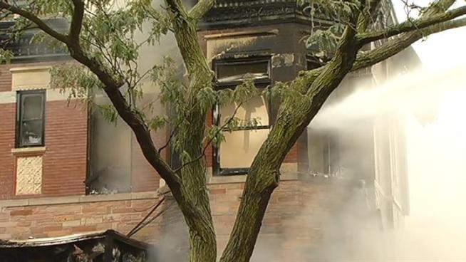 A vintage building once used as a funeral home collapsed during a raging, two-alarm fire in Lincoln Park on Friday afternoon.