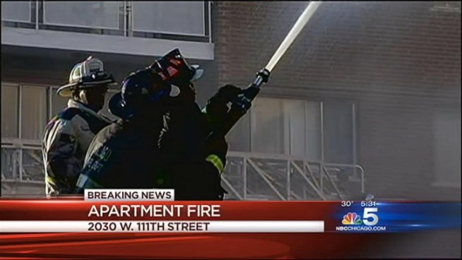 Firefighters continue to put out the flames of a 3-11 alarm fire in an apartment in Morgan Park neighborhood. Emily Florez reports for NBC News at 5 p.m. on Saturday, Nov. 24, 2012.