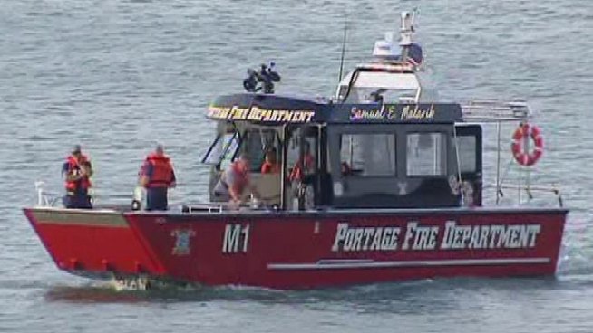 A Marine from Lockport swam into the lake to rescue the woman, but a man remains missing. Rob Elgas reports.