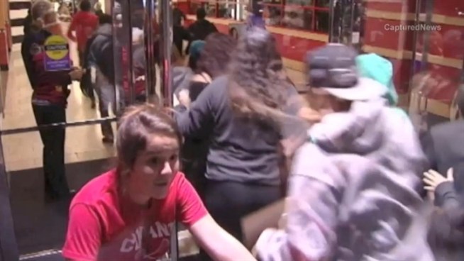 A crush of shoppers pushed their way into Woodfield Mall at midnight on Black Friday. It was one of several hectic scenes across the area.