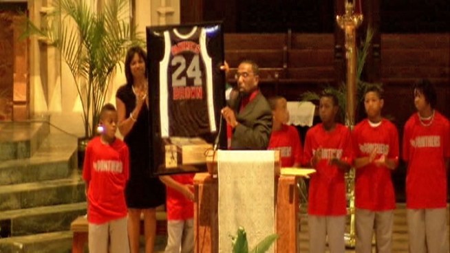 As family and friends embraced, basketball teammates of Darius Brown retired the jersey of a boy who had dreams of making it to the NBA.