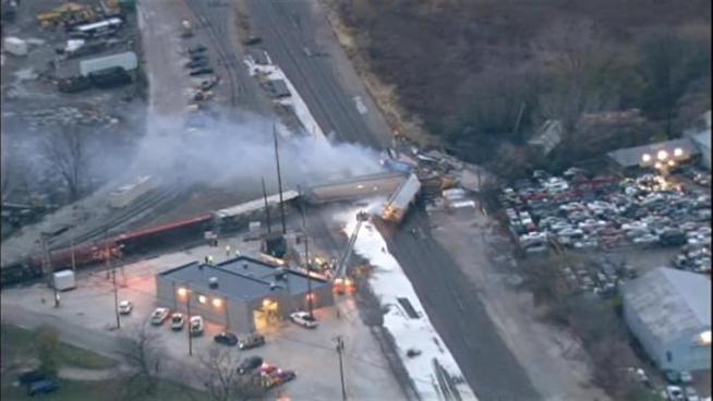 Fire crews extinguished on and off flames and began cleanup after a northbound Canadian National freight train derailed after 5 a.m. Thursday.