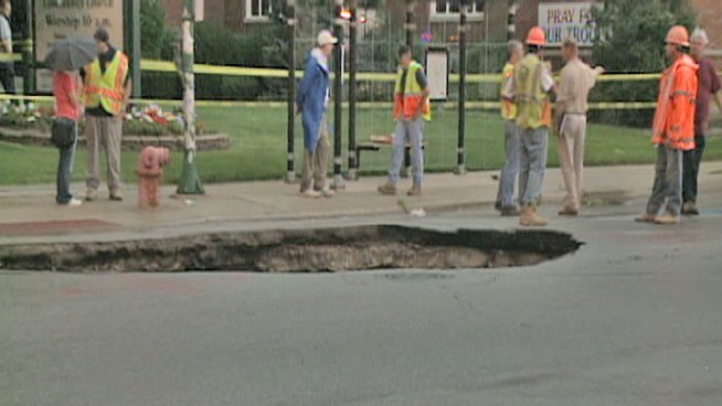 A man in his 30s said to be in good condition after the Acura he was driving plunged into a sinkhole and flipped upside down on the Northwest Side Saturday morning.