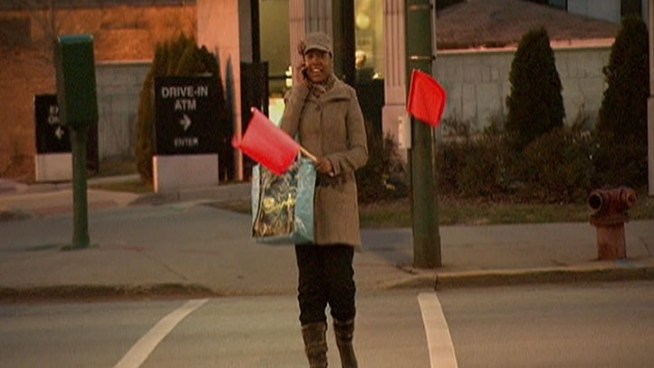 Small red street-crossing flags were placed in plastic holders in crosswalks at 10 intersections across Chicago Thursday for pedestrians to make themselves more visible to drivers when crossing the street.