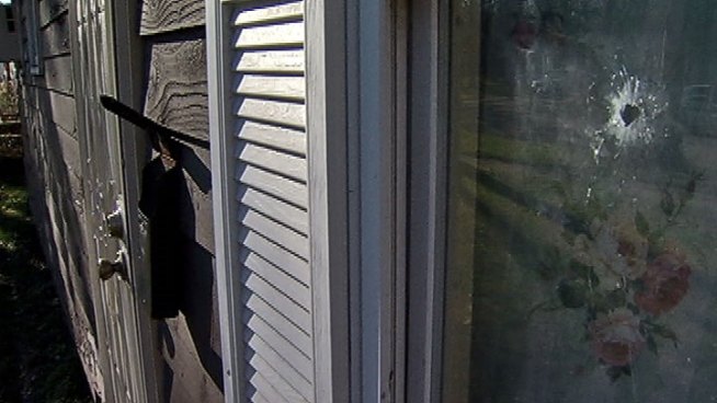 Shots fired across the street from Gary, Ind., home pierced family's living room, injuring two.