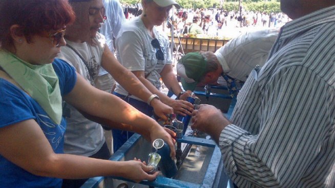 NATO protesters at Chicago's Grant Park douse their caps, fill their water bottles and wait in long lines on a very hot and humid Sunday in Chicago.
