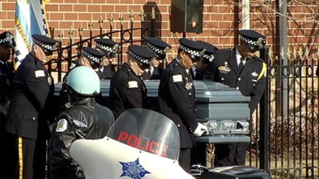 Hundreds of police officers, family and friends crowd a South Side church to pay tribute to fallen Chicago Police Officer Clifton Lewis.