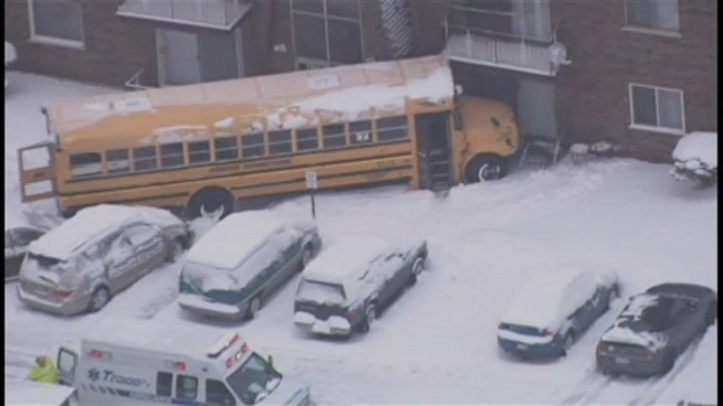 No injuries were reported when a school bus slid off the road Tuesday morning and into the apartment complex at 166th Street and Jean Lane.