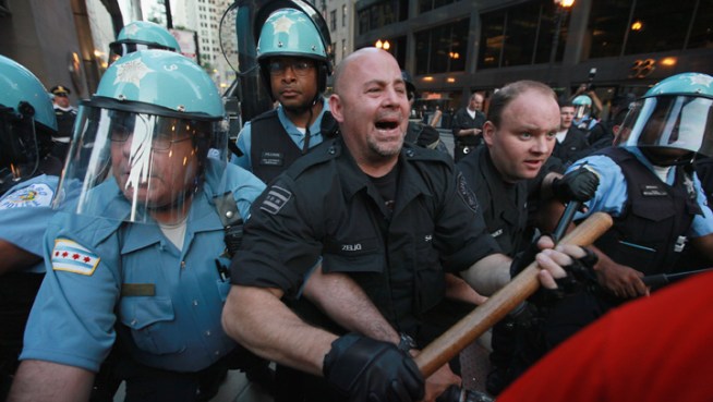 Officers in riot gear collide with demonstrators in Chicago's Loop.