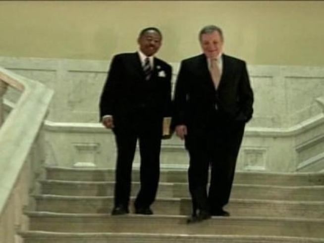 Senator Dick Durbin and Senator-Designate Roland Burris walk past the famous Francis Bicknell Carpenter painting hanging in the West Staircase of the Capitol, depicting President Lincoln's signing of the Emancipation Proclamation.