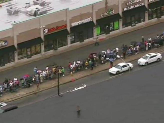 Hundreds of people lined up for blocks Wednesday, waiting to get financial assistance in the wake of the flooding that ravaged the area in late July.