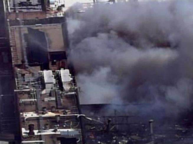 Firemen battle blaze at Patrick Cudahy meat packing plant in south Milwaukee. Many residents of the area had to evacuate.