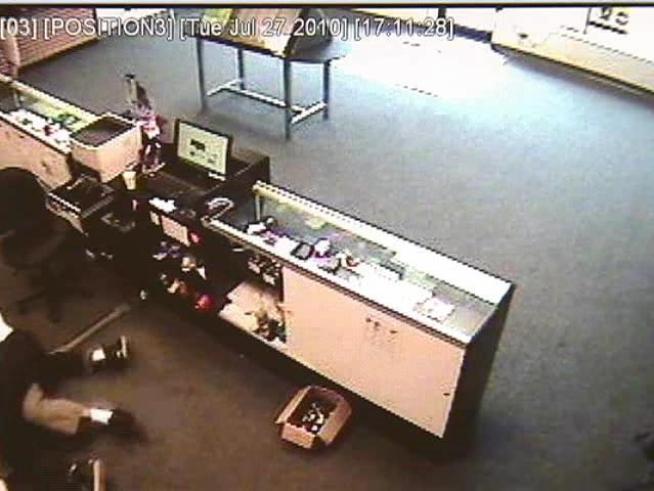 A woman was grazed in the arm by a bullet when a robber holds up a Cricket Wireless store.