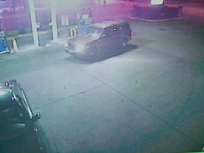 A red SUV cutting through the driveway of a Marathon gas station on the city's South Side to avoid a red light struck a man on the street and drove away.