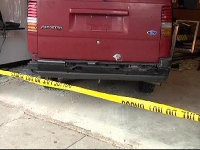 A driver lost control of his van, hit the gas instead of the brakes and drove into the <a title=
