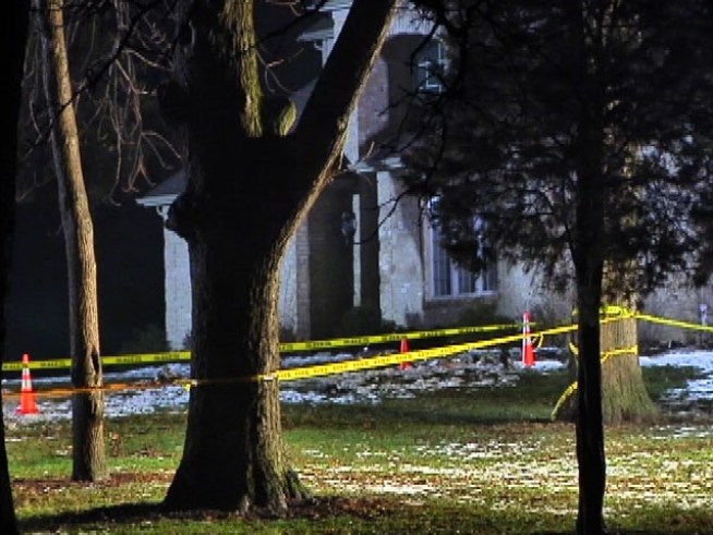 Two men are dead after their plane crashes into the ground, sending bits of metal flying into a nearby home.
