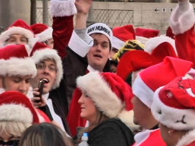 Hundreds of holiday-loving Santas descend on downtown <a title=