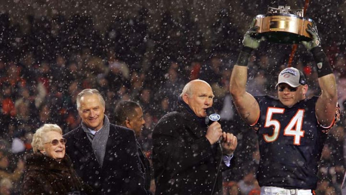 Chicago Bears chairman Michael McCaskey, left, and owner Virginia McCaskey  , center, react as they are presented with the George Halas Trophy after  the Bears beat the New Orleans Saints, 39-14, to