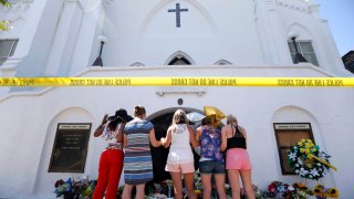 In this June 18, 2015, file photo, a group of women pray together at a make-shift memorial on the sidewalk in front of the Emanuel AME Church in Charleston, South Carolina. Wednesday marks the fifth anniversary of the shooting.
