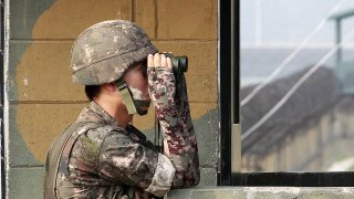 In this July 13, 2014, file photo, a South Korean army soldier looks through a pair of binoculars at a military check point at the Imjingak Pavilion near the border with North Korea.