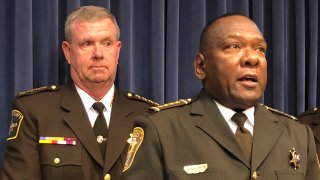 Kankakee County Sheriff Mike Downey, left, joins Livingston County Sheriff Tony Childress, right, at the state Capitol Tuesday, Feb. 25, 2020, in Springfield, Illinois. Both men protested the end of a practice by the Illinois Department of Corrections to transfer released inmates who have warrants or immigration detainers to Pontiac Correctional Center, where the Kankakee Sheriff's Department picked them up and detained them for U.S. Immigration and Customs Enforcement for deportation hearings.