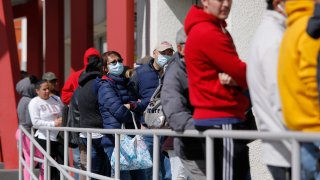 People wait in line for help with unemployment benefits at the One-Stop Career Center, Tuesday, March 17, 2020, in Las Vegas.