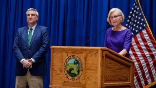 Indiana Health Commissioner Dr. Kristina Box answers questions about COVID-19 infections and its impact on the state as Indiana Gov. Eric Holcomb listens during a briefing at the Statehouse in Indianapolis, Tuesday, March 24, 2020. Holcomb ordered state residents to remain in their homes except when they are at work or for permitted activities, such as taking care of others, obtaining necessary supplies, and for health and safety. The order is in effect from March 25 to April 7.