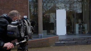 A cameraman films the glass door which was smashed during a break-in at the Singer Museum in Laren, Netherlands