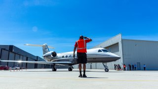 Life Service crew member Maurice Payne, salutes members of a delegation of California based-physicians onboard of a Gulfstream IV jet aircraft
