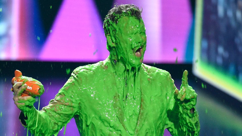 Chris Pratt reacts after getting slimed as he accepts the award for favorite butt-kicker for "Jurassic World: Fallen Kingdom"