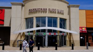 Shoppers leave the Greenwood Park Mall, Monday, May 4, 2020, in Greenwood, Ind.