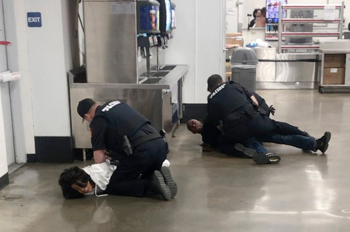 In this March 23, 2020 frame grab taken from video, Marvia Gray, left and her son Derek Gray are arrested at a Sam's Club store in Des Peres, Missouri. A lawsuit filed Monday May 18, 2020, accuses four white suburban St. Louis police officers of brutalizing Gray and her adult son after wrongly accusing them of stealing a television. Gray alleges she suffered serious and permanent injuries during her arrest. Her 43-year-old son, Derek, suffered a concussion, three shattered teeth and other injuries, according to the lawsuit.