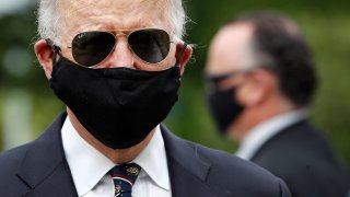 Democratic presidential candidate, former Vice President Joe Biden wears a face mask to protect against the spread of the new coronavirus as he and Jill Biden depart after placing a wreath at the Delaware Memorial Bridge Veterans Memorial Park, Monday, May 25, 2020, in New Castle, Del.