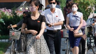 People wearing masks walk in the Ryomyong street in Pyongyang, North Korea Friday, July 3, 2020. North Korean leader Kim Jong Un urged officials to maintain alertness against the coronavirus, warning that complacency risked “unimaginable and irretrievable crisis,” state media said Friday.