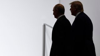 In this June 28, 2019, file photo, President Donald Trump and Russian President Vladimir Putin walk to participate in a group photo at the G20 summit in Osaka, Japan.