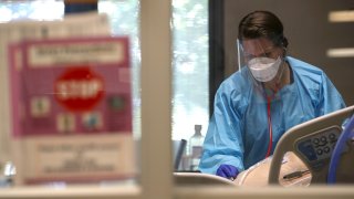In this May 21, 2020, file photo, a nurse evaluates a coronavirus COVID-19 patient in the intensive care unit (I.C.U.) at Regional Medical Center in San Jose, California.