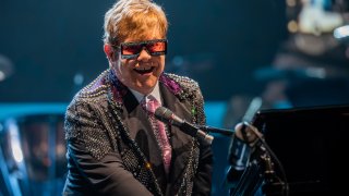 Elton John is hosting a “living room” concert aimed at bolstering American spirits during the coronavirus crisis and saluting those countering it.