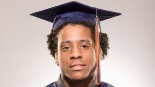 Portrait of a male high school graduate wearing cap and gown