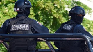File photo - Policemen stand guard in the area where heavily armed gunmen waged an all-out battle against Mexican security forces in Culiacan, Sinaloa state, Mexico, on Oct. 18, 2019.