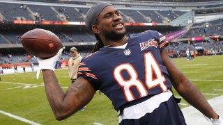 Cordarrelle Patterson throws a football to a fan during a Bears game at Soldier Field