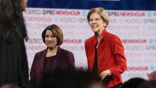 Democratic presidential candidates Sen. Elizabeth Warren, D-Mass., and Sen. Amy Klobuchar, D-Minn., walk on the stage after the Democratic presidential primary debate at Loyola Marymount University on Dec. 19, 2019, in Los Angeles.