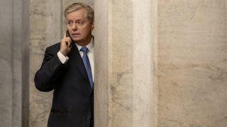 Sen. Lindsey Graham, R-S.C., speaks on a mobile phone while arriving at the U.S. Capitol in Washington, on Feb. 5, 2020.