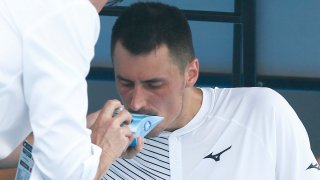 Bernard Tomic of Australia receives medical attention in his match against Denis Kudla of the USA during the Australian Open Qualifying at Melbourne Park on Jan. 14, 2020 in Melbourne, Australia.